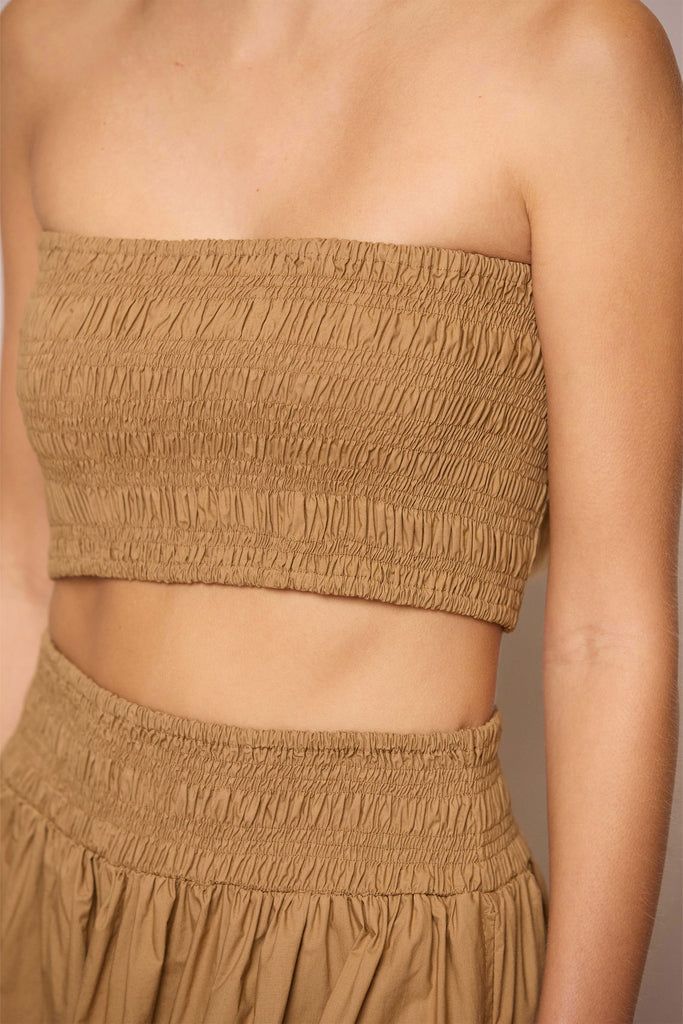 The simplicity of the Siwa is what makes this top oh so sophisticated. Pair with its matching Manui skirt or the Sabine Pant for a casual cool edit. This smocked crop top will be at the top of our drawers for the warmer, balmy days. Semi-stitched Slub Silk Sets For Festivals, Brown Cotton Top With Ribbed Cuffs, Solid Moisture-wicking Crop Top For Yoga, Bohemian Tie-dye Cotton Crop Top, Brown Stretch Crop Top With Built-in Bra, Bra Sizes, Strappy Sandals, Polished Look, Smocking