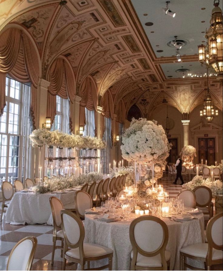 an elegant ballroom with chandeliers and tables set up for a formal dinner or reception