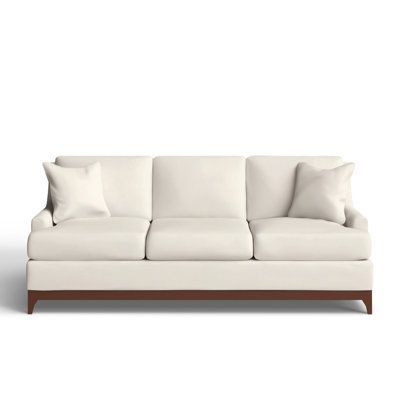 a white couch with pillows on it