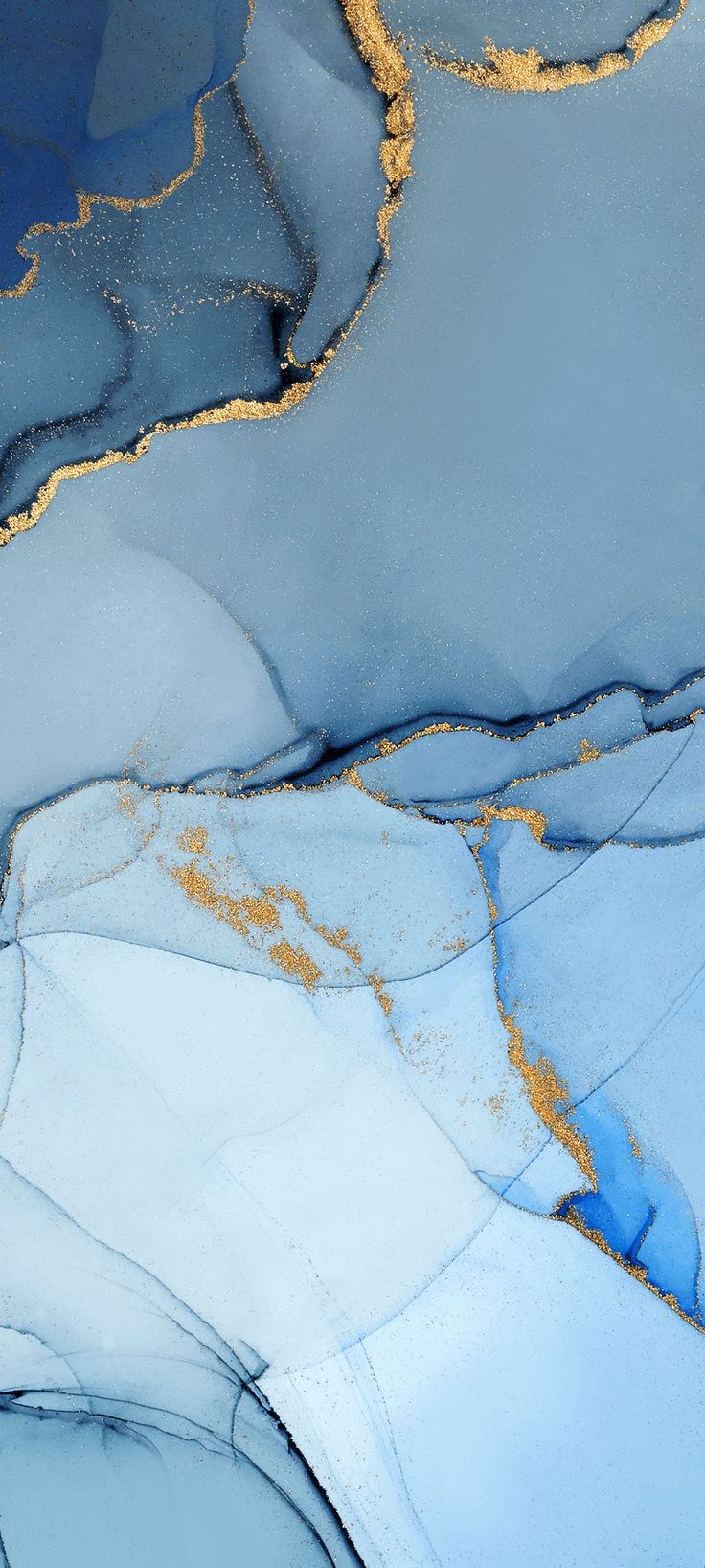 an aerial view of blue and gold paint on the ground, with water in the foreground