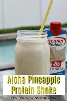 a mason jar filled with aloha pineapple protein shake next to a pool