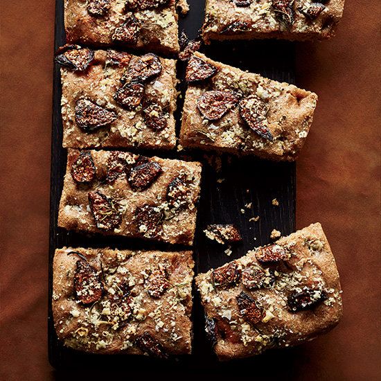 some food that is sitting on a black plate and brown table cloth with it's cut into squares