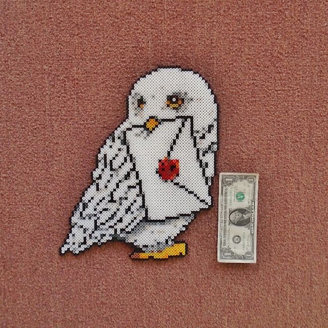 a white bird with a red heart on it's chest next to a one dollar bill