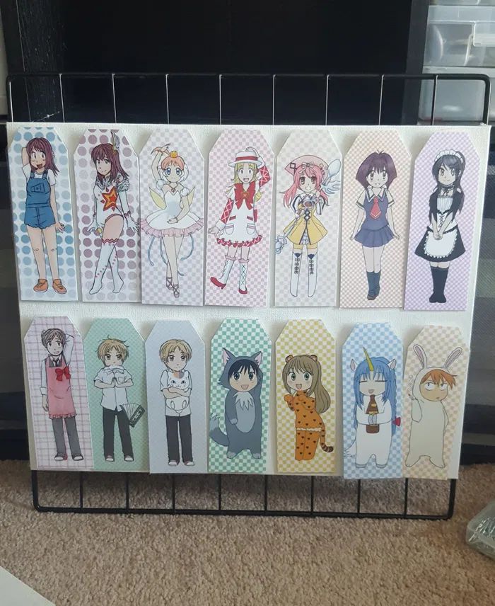 a bunch of anime characters are hanging on a rack