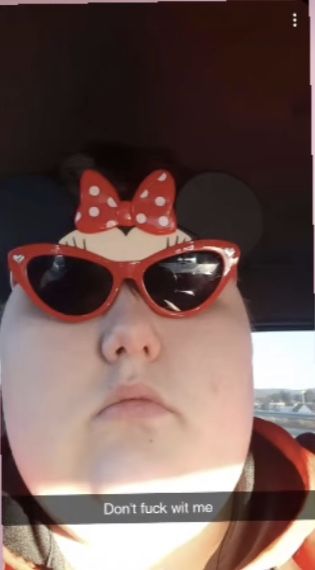 a person wearing sunglasses with minnie mouse on them