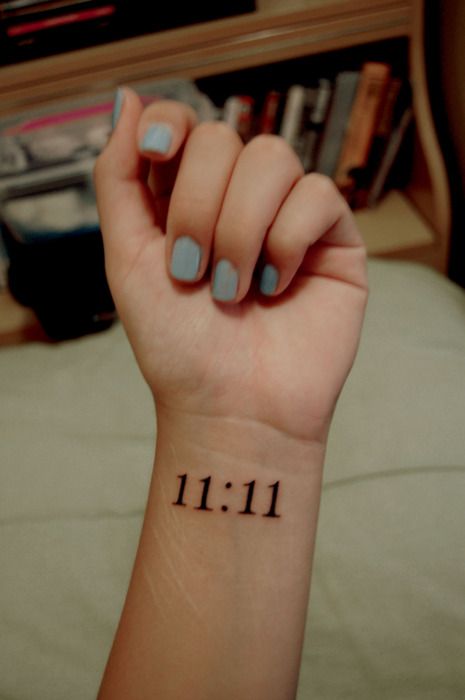 a woman's wrist with the number 11 on it