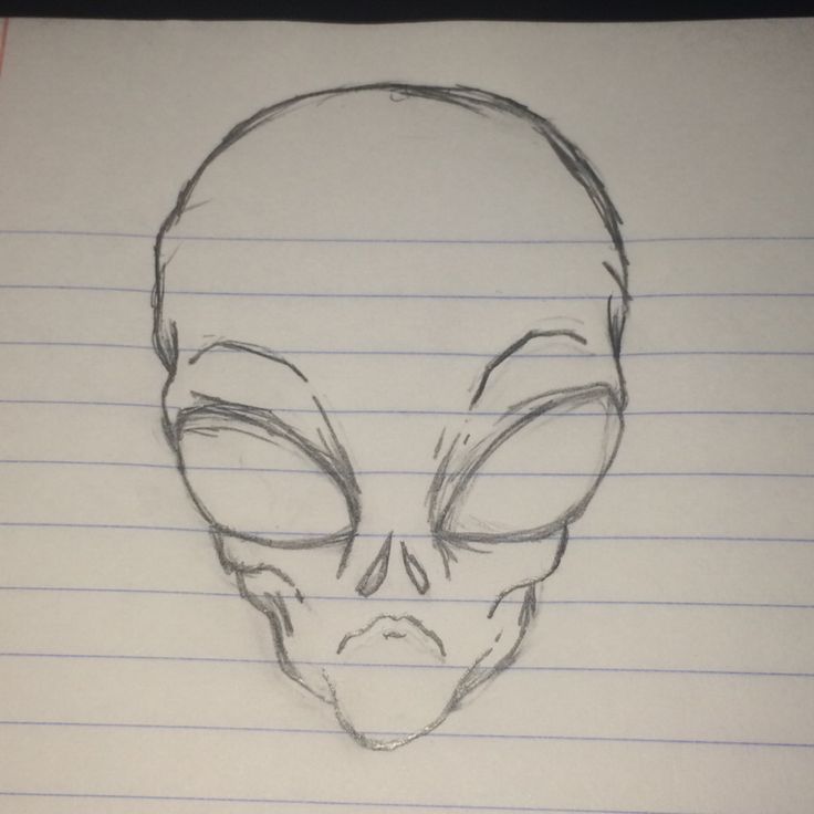 a drawing of an alien head on lined paper