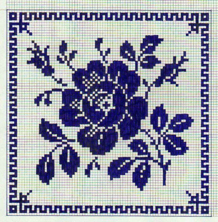 a blue and white cross stitch pattern with flowers on the front, in square format