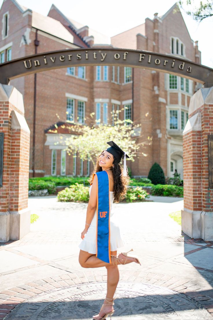 a woman in a graduation cap and gown poses for a photo at the university of florida