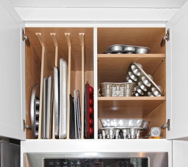 an open cabinet filled with dishes and pans