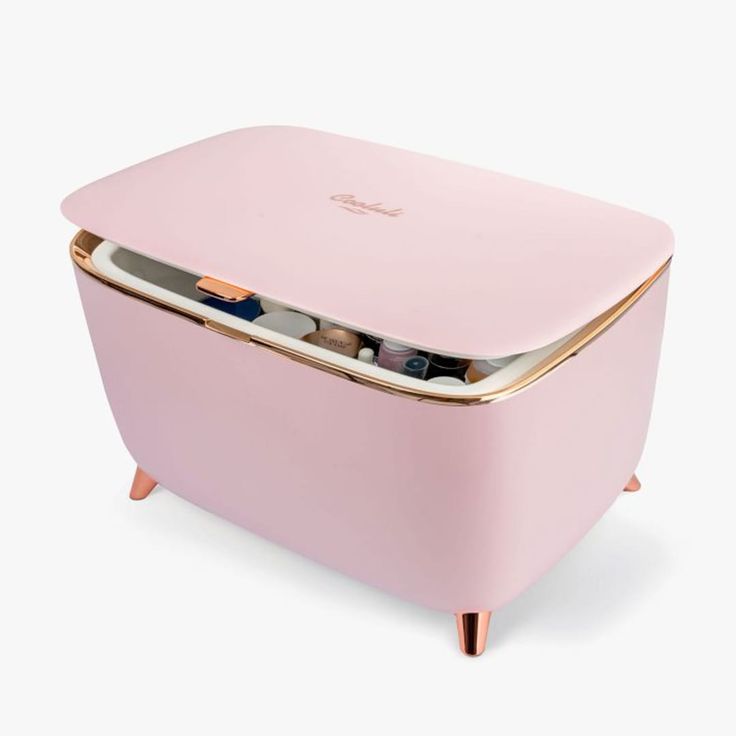 a pink icebox with gold trimmings on it