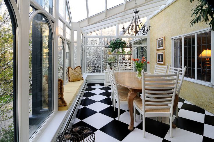 a dining room with black and white checkered flooring on the walls, windows, and ceiling