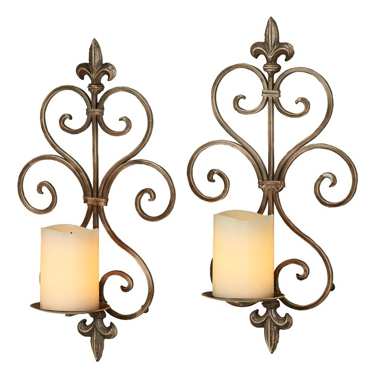 two wall sconces with candle holders on each side and one light in the middle