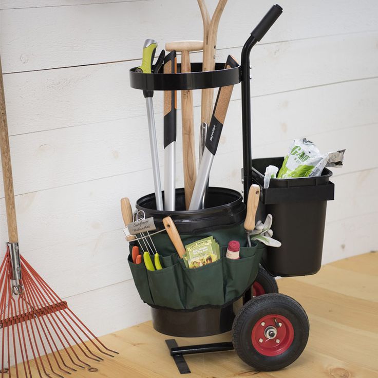 a garden tool caddy with gardening utensils in it