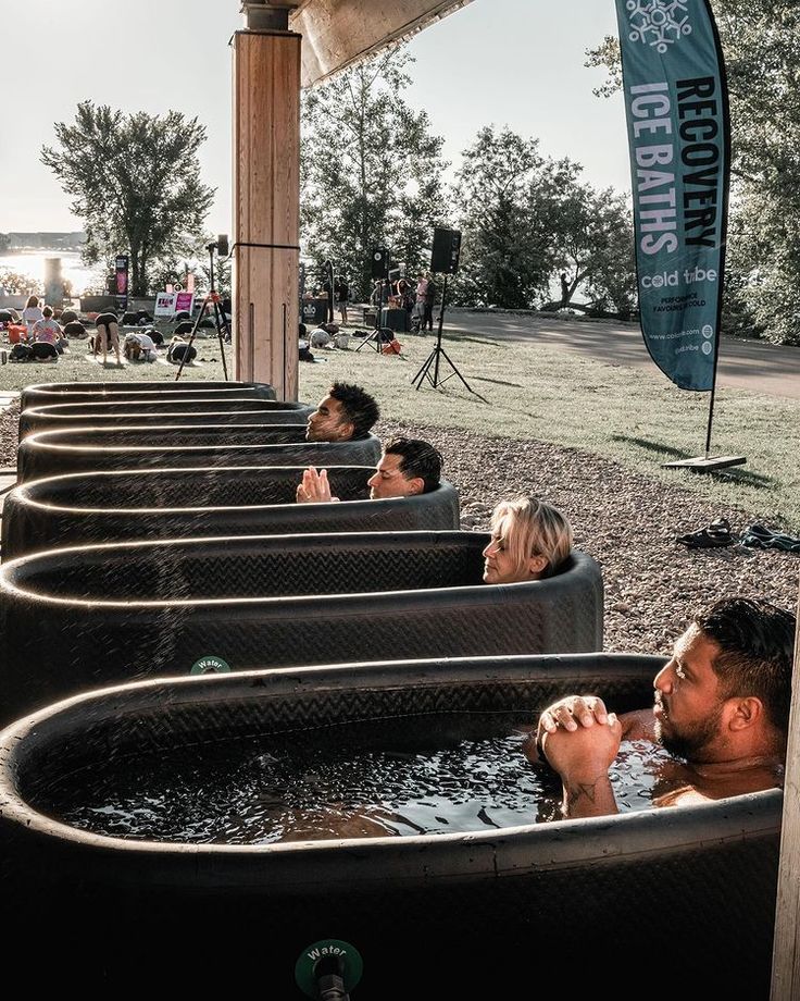 several people sitting in an outdoor hot tub