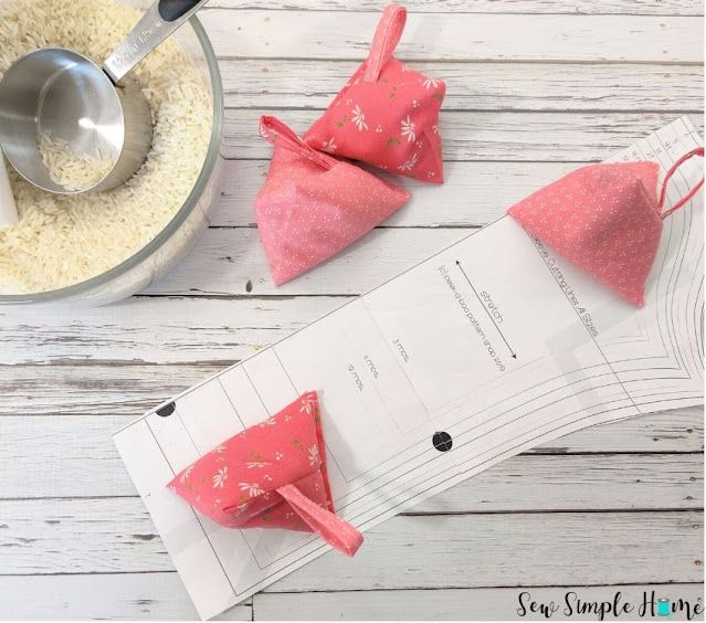 two pink bow ties sitting on top of a piece of paper next to a measuring cup