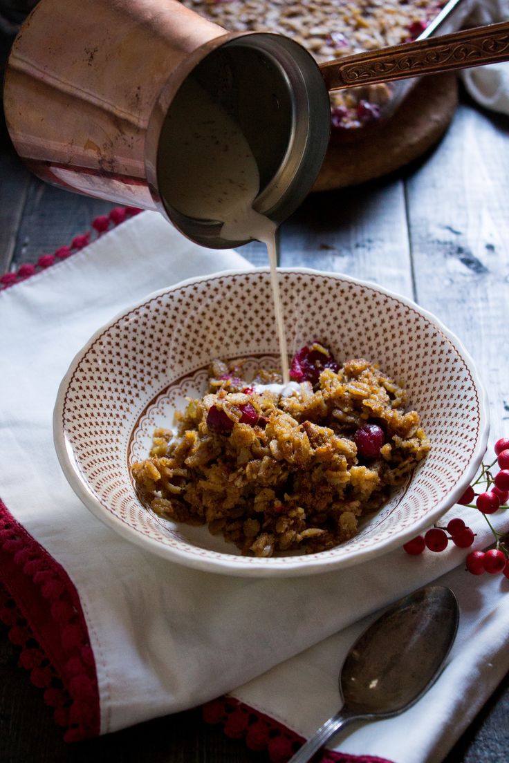 a bowl filled with granola sitting on top of a table