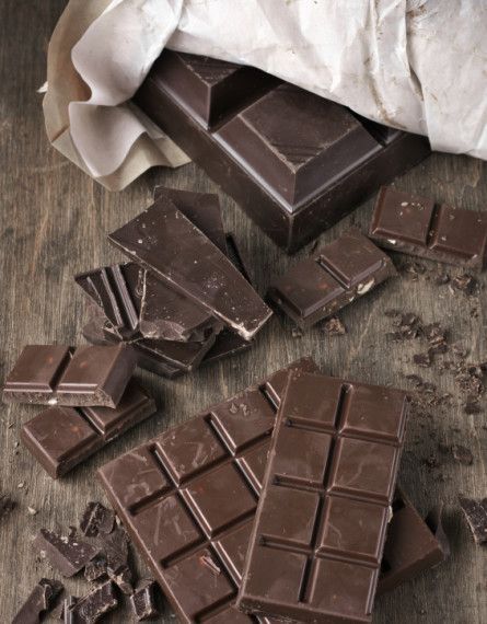 pieces of chocolate sitting on top of a wooden table