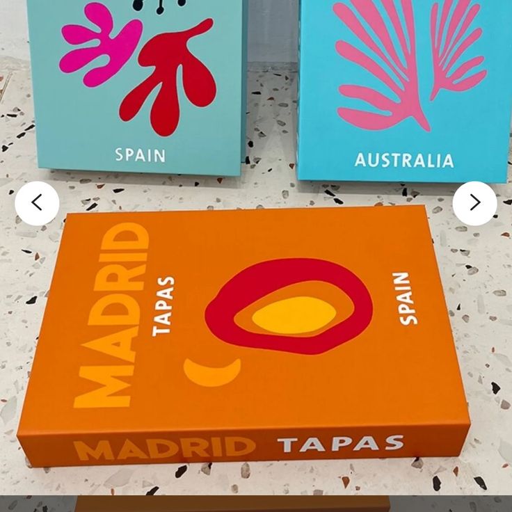 three boxes with different designs on them sitting next to each other