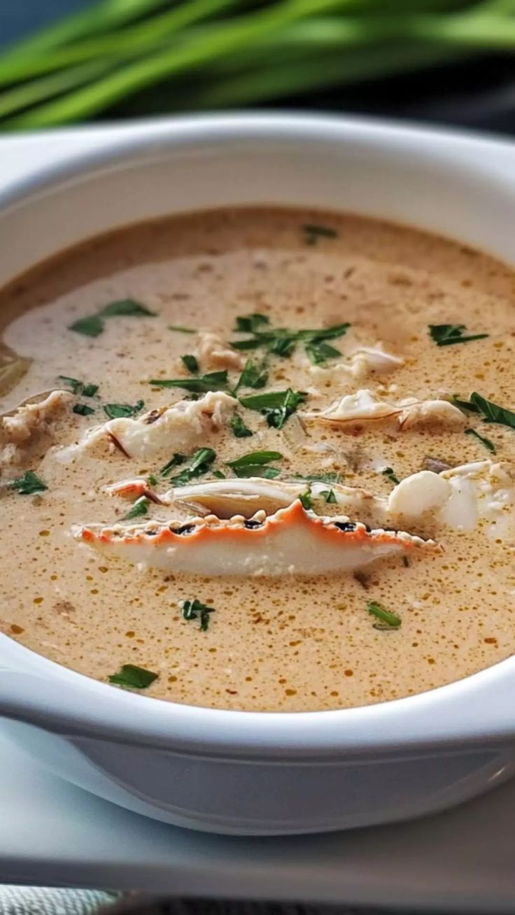 a white bowl filled with soup on top of a table