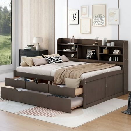 a bed sitting in a bedroom next to a bookcase filled with books on top of a hard wood floor