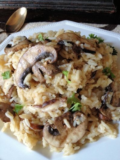 a white plate topped with rice and mushrooms