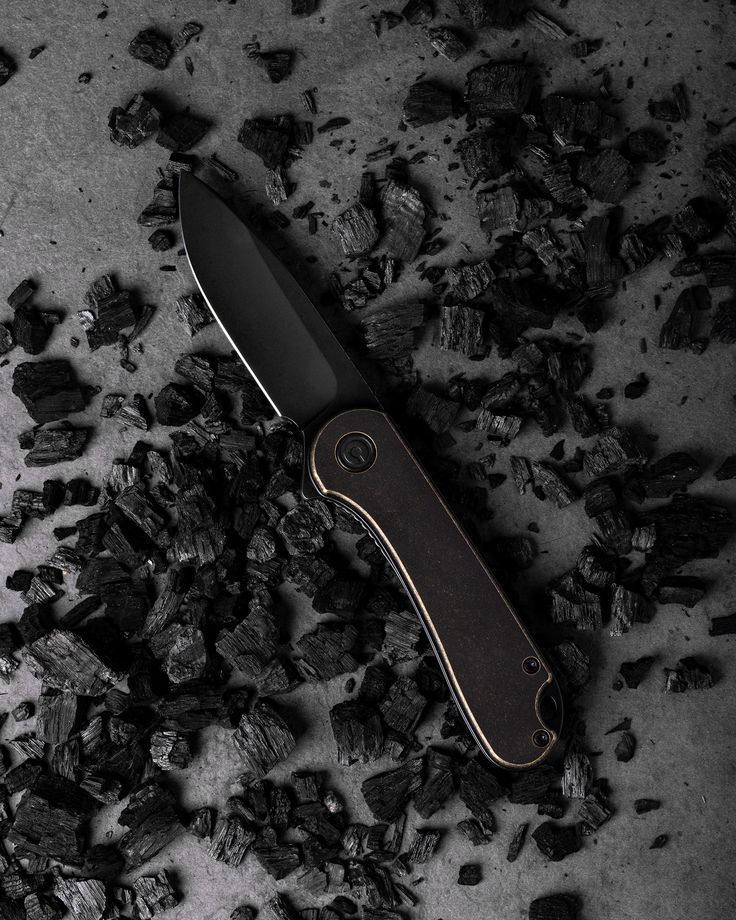 a knife sitting on top of a pile of coal