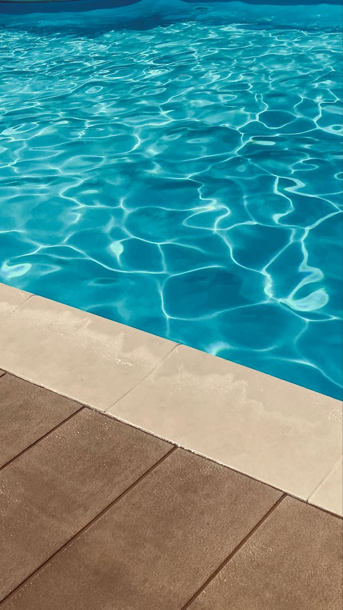 an empty swimming pool with blue water