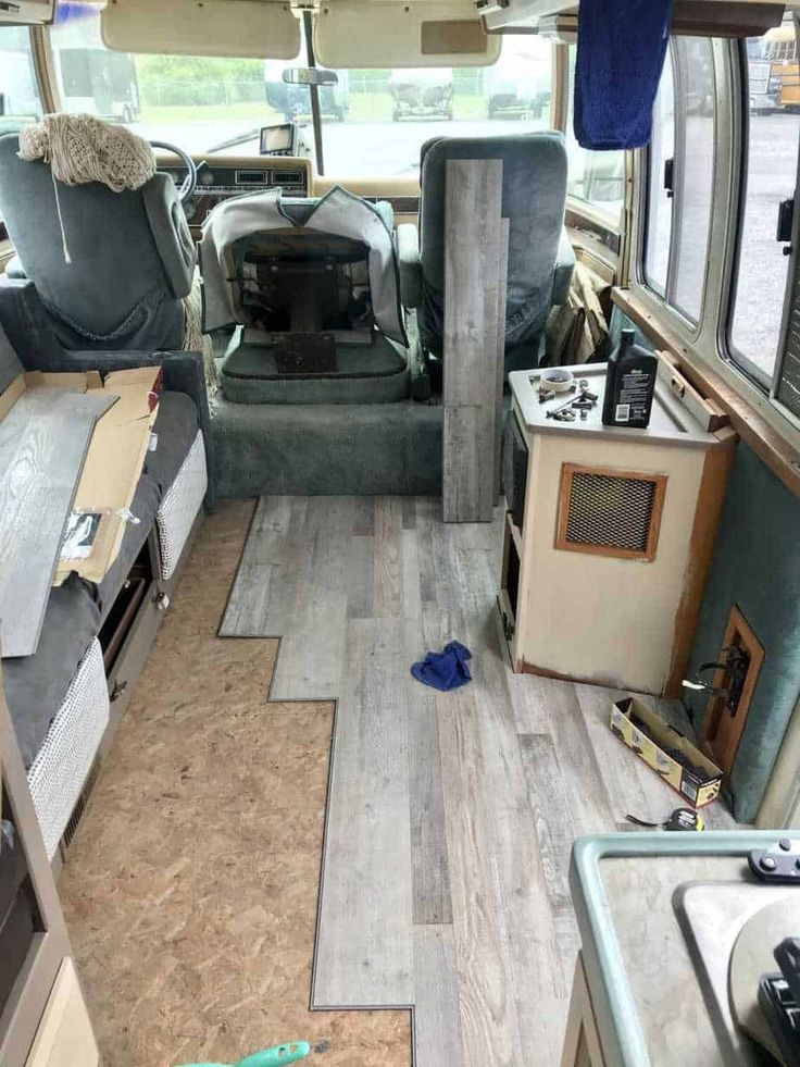 the inside of an rv with wood flooring and furniture in it's interior