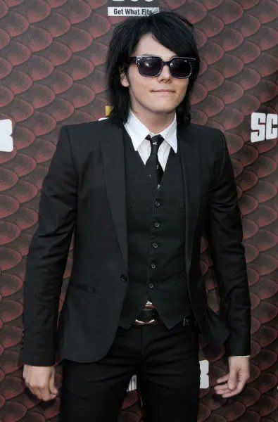 a man in a suit and sunglasses on the red carpet