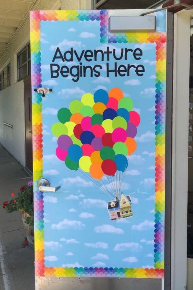 a sign advertising an adventure begins here in front of a building with balloons flying above it