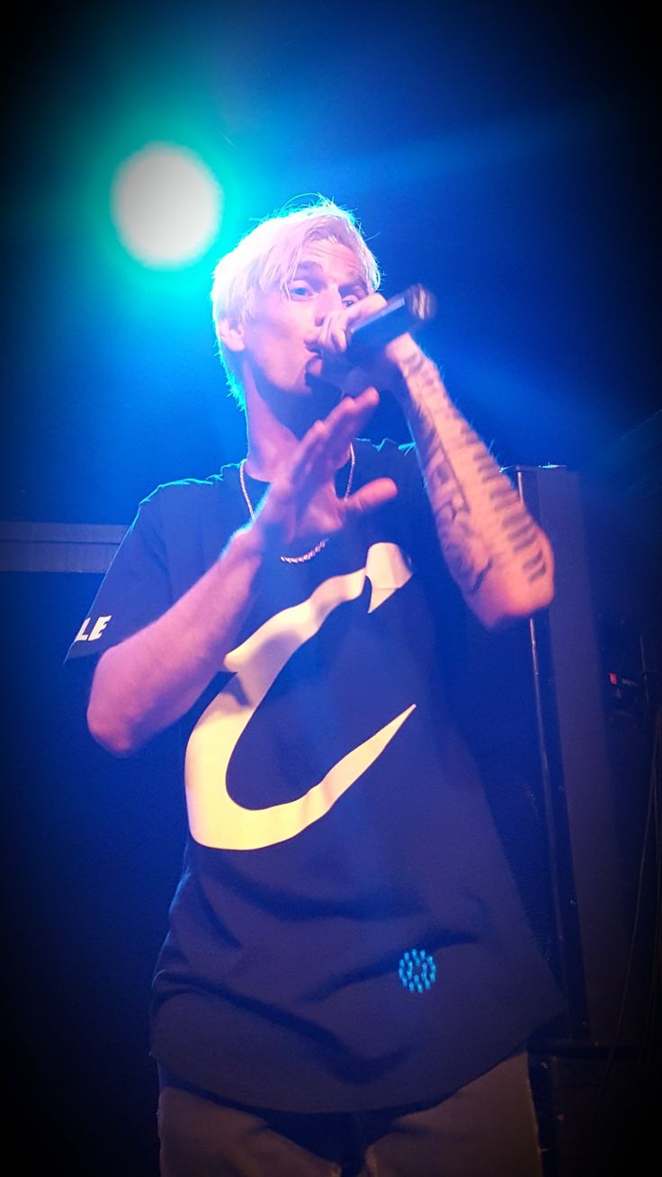 a man standing on stage holding a microphone