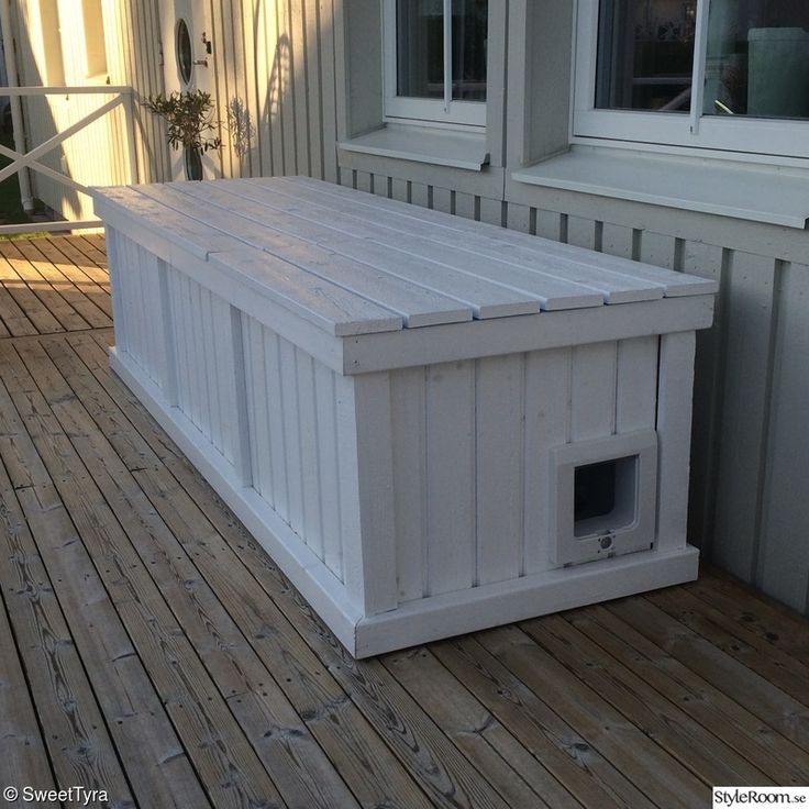 a dog house made out of pallets on a deck