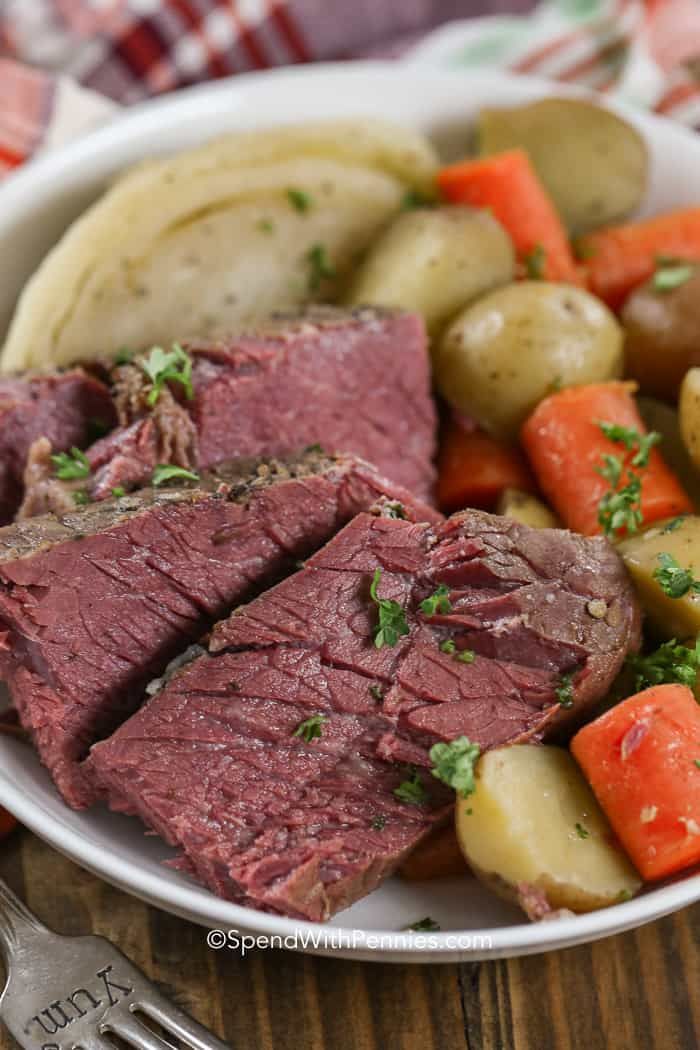 a bowl filled with meat, potatoes and carrots