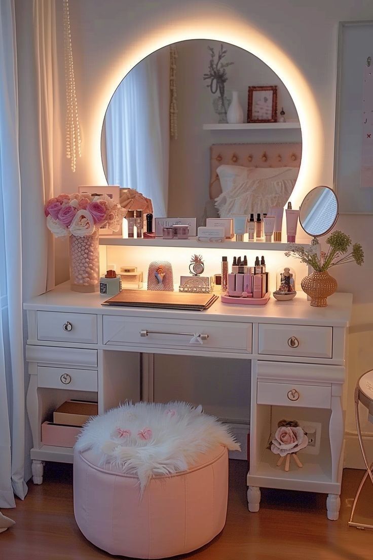 a vanity with a mirror, stool and other items on the table in front of it