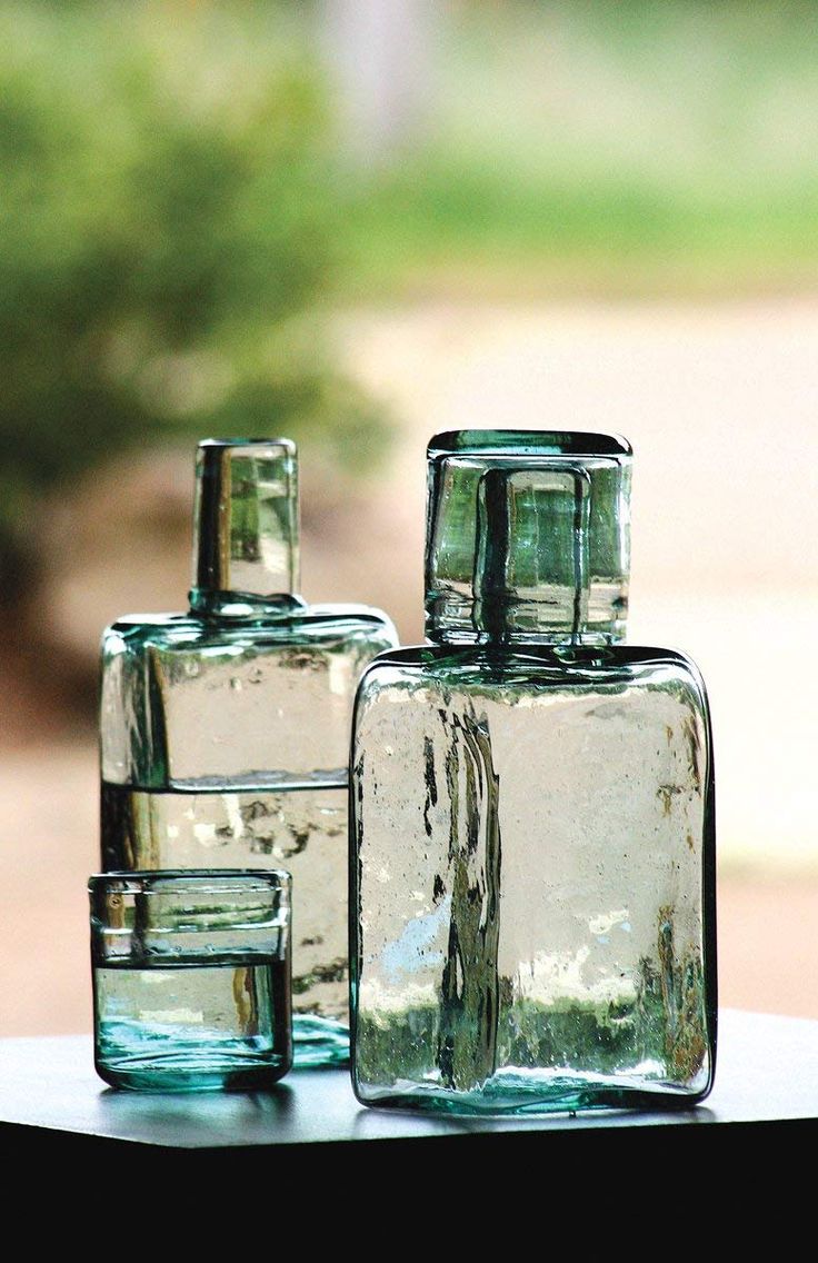 three glass bottles sitting on top of a table next to each other with the words, the rustic pelican