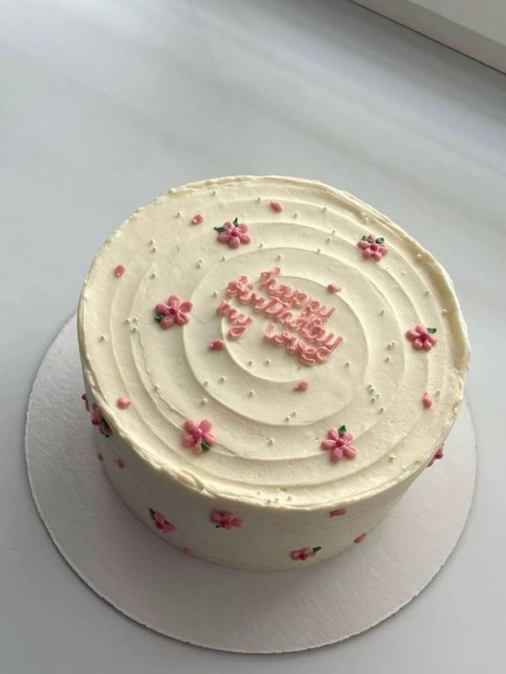 a white cake with pink flowers on it