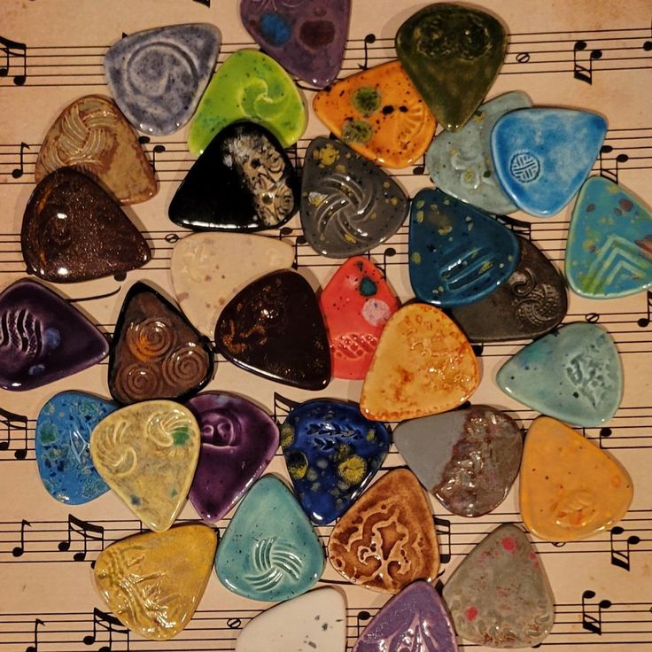 a group of guitar picks sitting on top of musical notes