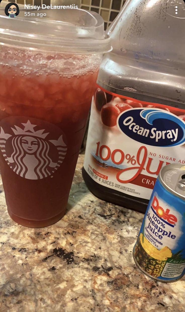 a cup of iced coffee next to a container of ice tea and a can of ocean spray