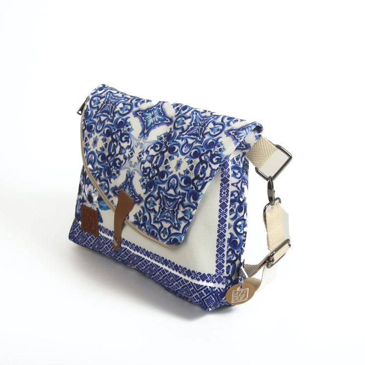 a small blue and white purse sitting on top of a table