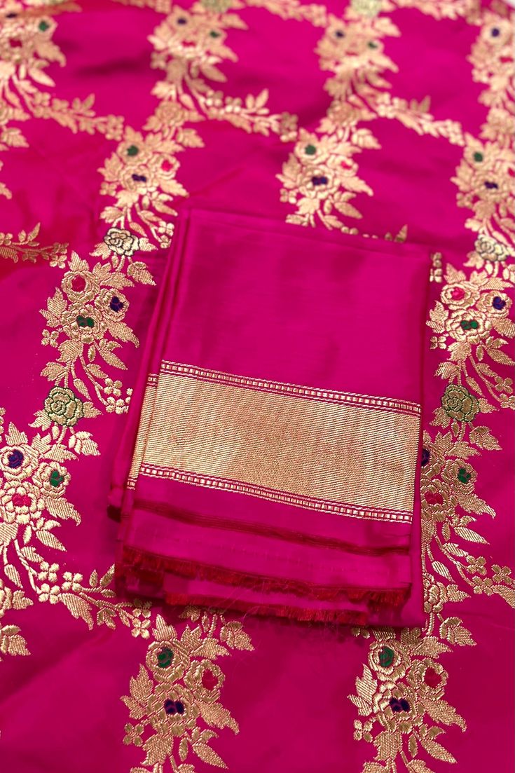 This exquisite handwoven banarasi katan silk saree in luxurious shade of pink with woven floral motifs, called jangla is nothing but regal. Traditional gold zari woven floral borders are highlighted with diya and lattice motifs. The pallu mirrors the borders, richly woven in gold zari. Approximate Length 6.5 mtrs (inclusive of blouse length)Height - 46 - 52" Saree comes with fall, picot and tassels done. Blouse piece is cut. Approximate weight - 1.8 lbs Kindly Note : The colors you see on your d Elegant Pink Jamawar Unstitched Suit, Elegant Pink Cutdana Dupatta, Pink Jamawar Unstitched Suit For Navratri, Gold Tussar Silk Bollywood Unstitched Suit, Gold Tussar Silk Unstitched Bollywood Suit, Pink Unstitched Suit With Resham Embroidery For Traditional Ceremonies, Bollywood Gold Tussar Silk Unstitched Suit, Pink Jamawar Unstitched Suit For Wedding, Wedding Unstitched Pink Jamawar Suit