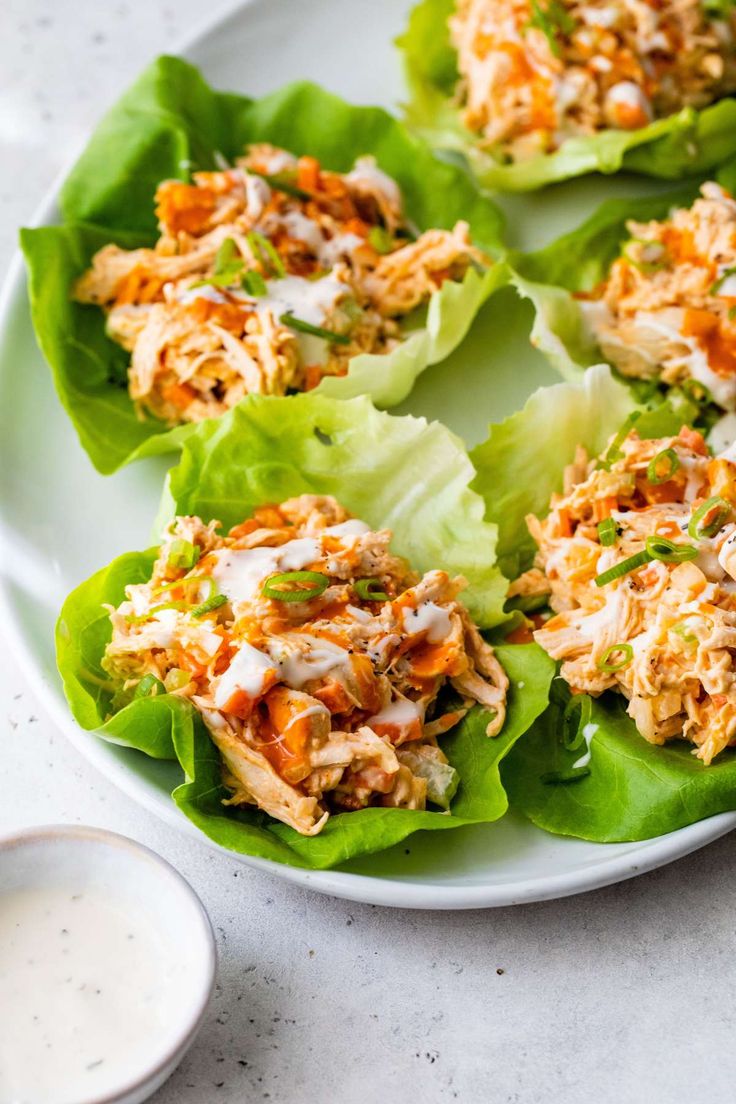 chicken lettuce wraps with ranch dressing on a white plate