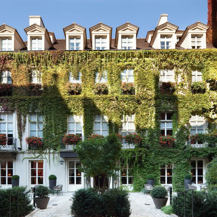 an apartment building covered in vines and flowers