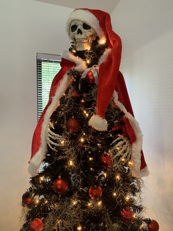 a decorated christmas tree with a skeleton on top