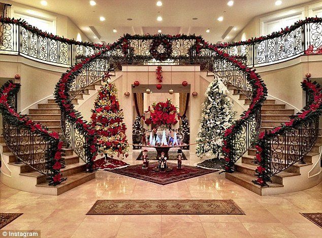 christmas decorations are on display in the entryway to a house with stairs and staircases