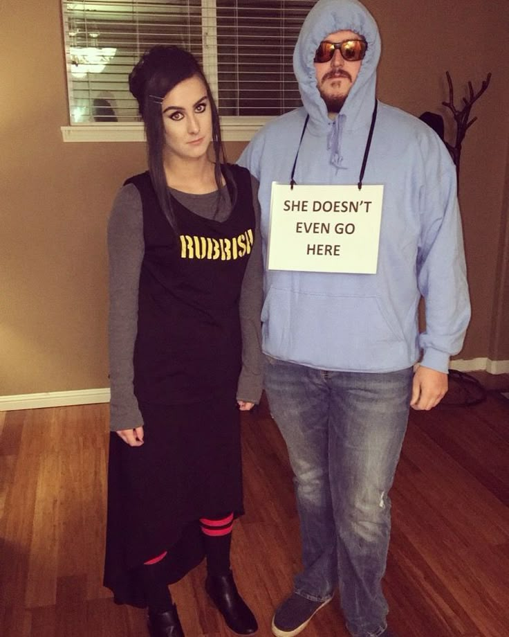 a man and woman dressed in costumes standing next to each other