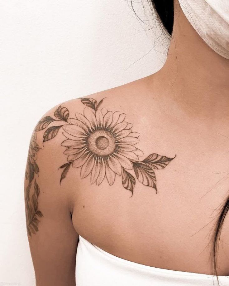 a woman with a sunflower tattoo on her chest