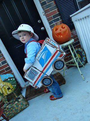 a young boy is holding a cardboard box with an electronic device on it's back