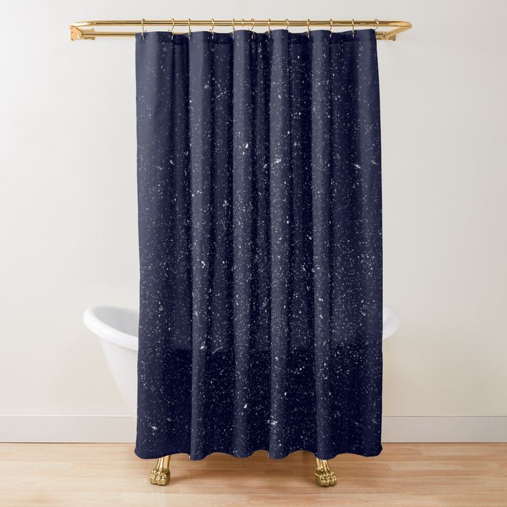 a shower curtain with blue speckles on it in front of a white bath tub