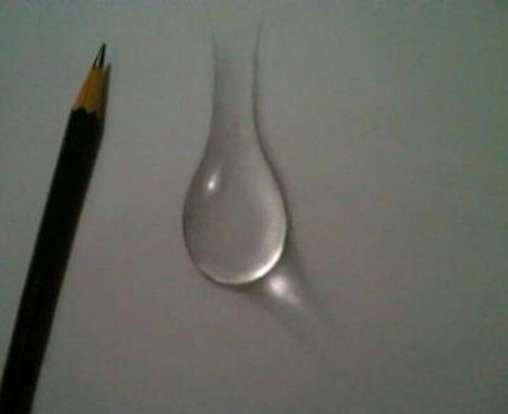 a pencil and water drop on top of a piece of paper